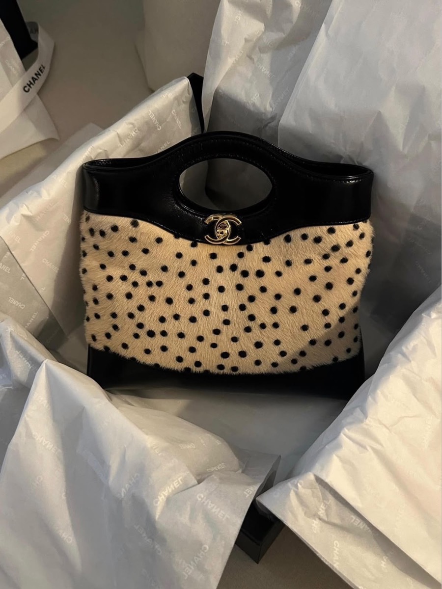 A Chanel handbag resting in branded tissue paper, just unwrapped