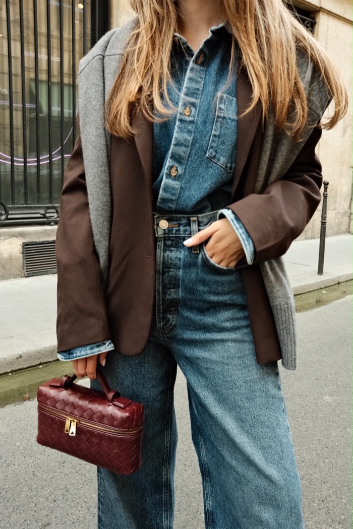 Street style: a brown blazer over denim with a burgundy top-handle bag